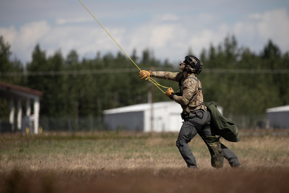 Alaska Air National Guardsmen showcase rescue demonstration during multi-agency hoist symposium