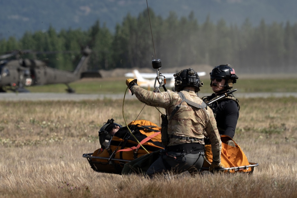 Alaska Air National Guardsmen showcase rescue demonstration during multi-agency hoist symposium