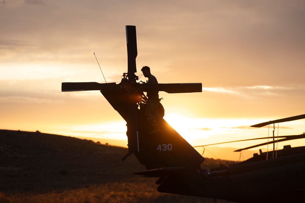 Washington National Guard Black Hawk helicopters at sunset