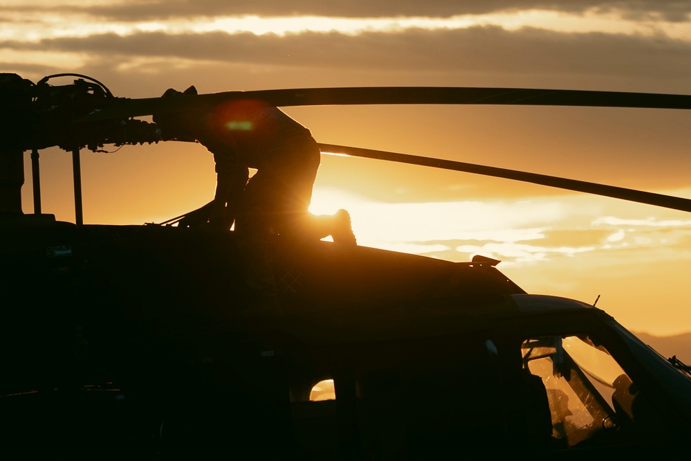 Washington National Guard Black Hawk helicopters at sunset