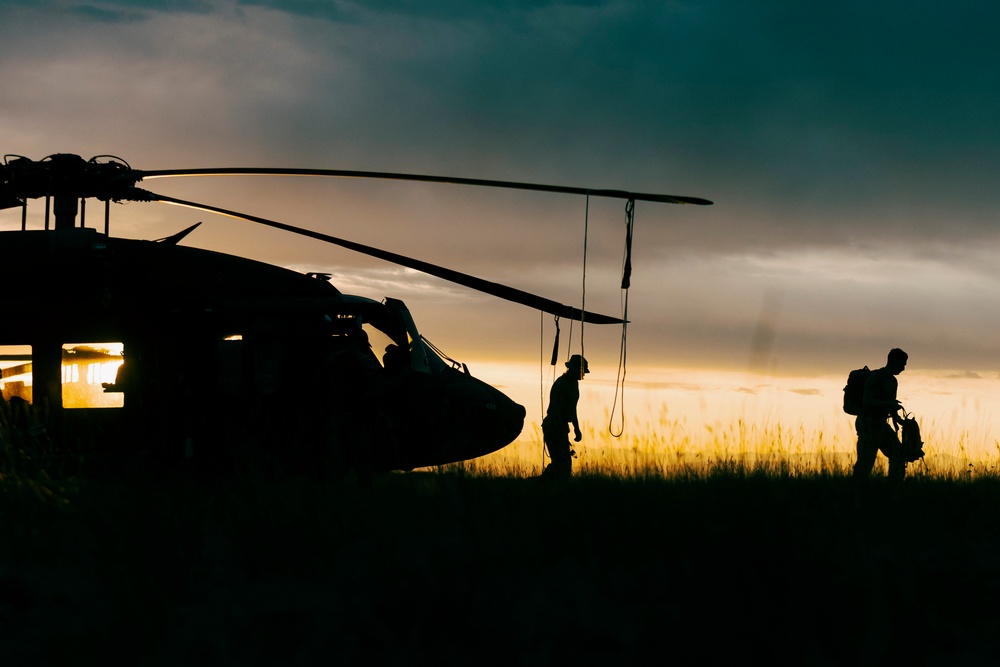 Washington National Guard Black Hawk helicopters at sunset