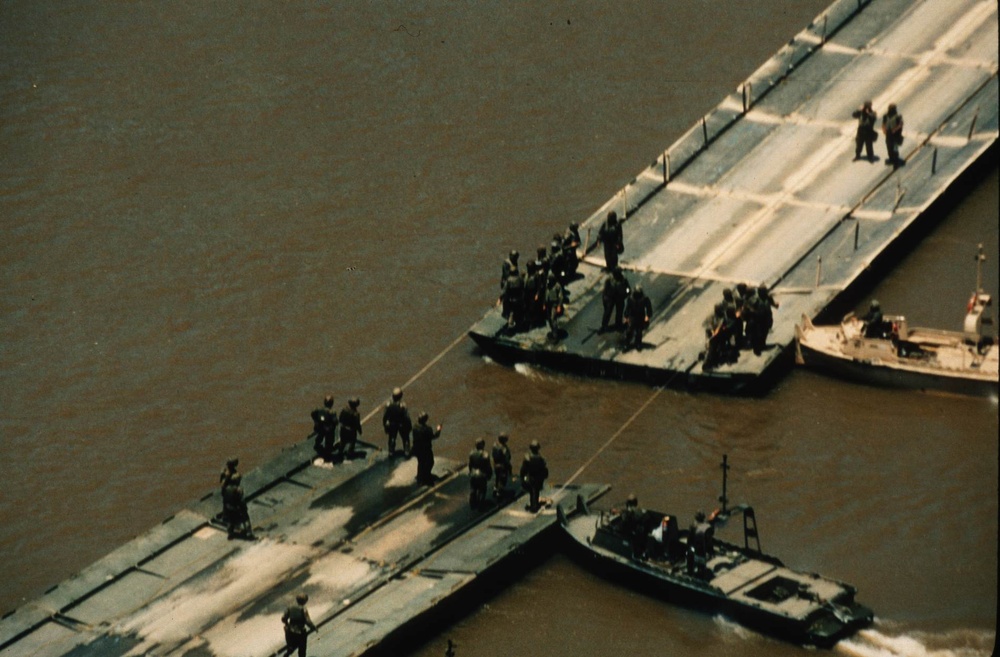 U.S. Army combat engineers join a ribbon float bridge