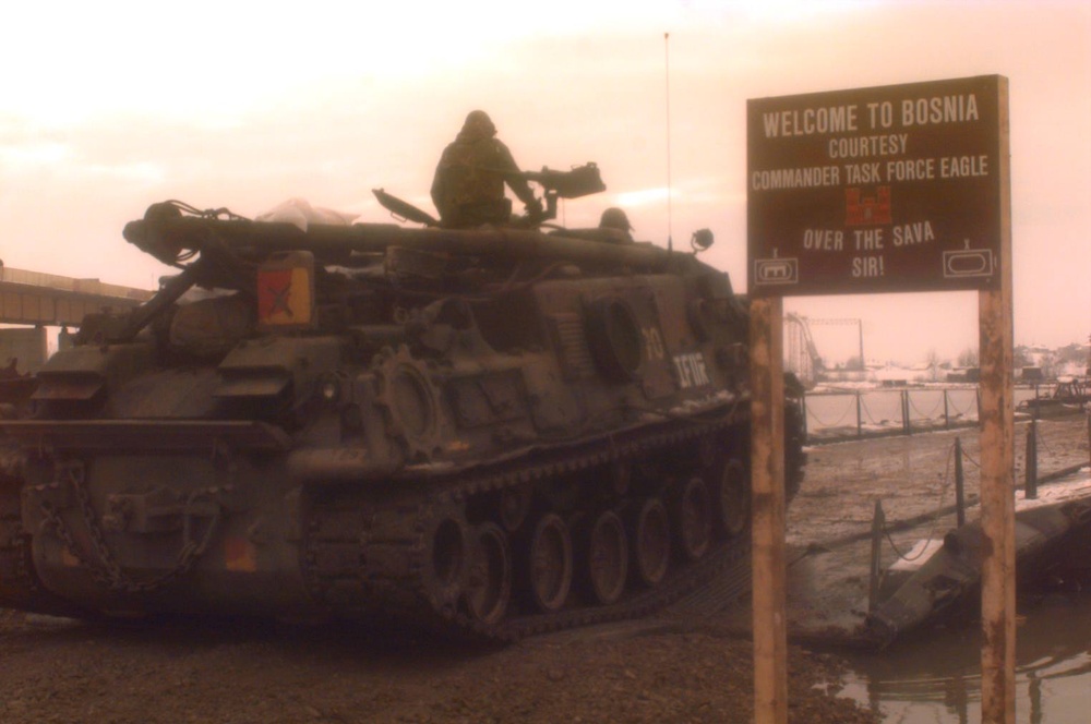 A U.S. Army M-88A 1 Recovery Vehicle drives onto the U.S. Army bridge over the Sava River at Zupania, Croatia.