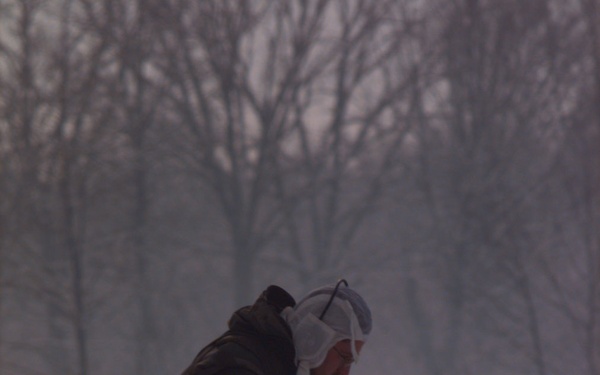 An explosive ordinance technician sweeps a path to a suspected anti-vehicle mine at Tuzla Air Base.