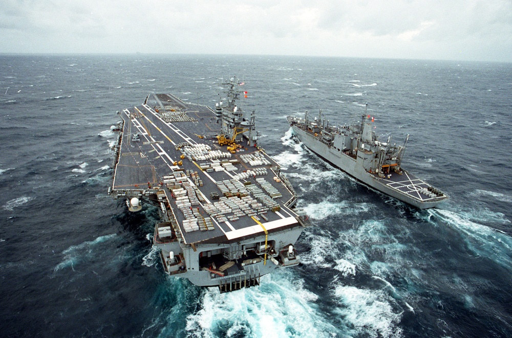 USS Theodore Roosevelt and USS Santa Barbara conduct a weapons on-load.
