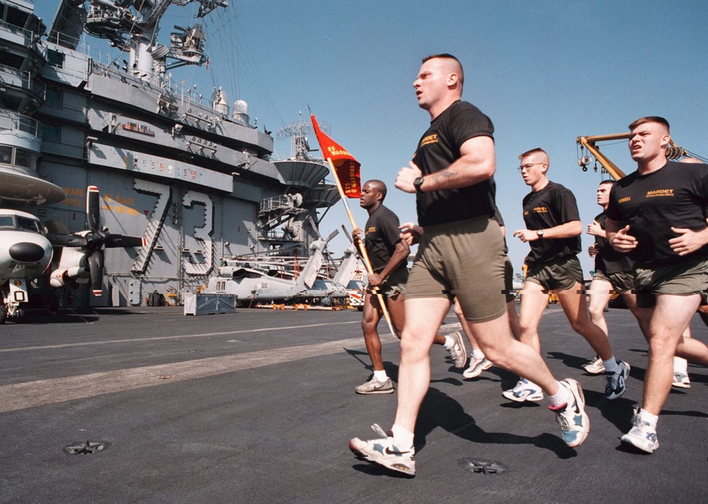 USS George Washington Marine Detachment runs across the flight deck.