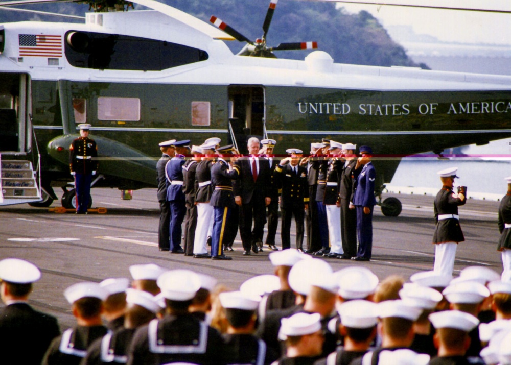 President Clinton is piped aboard the aircraft carrier USS Independence.