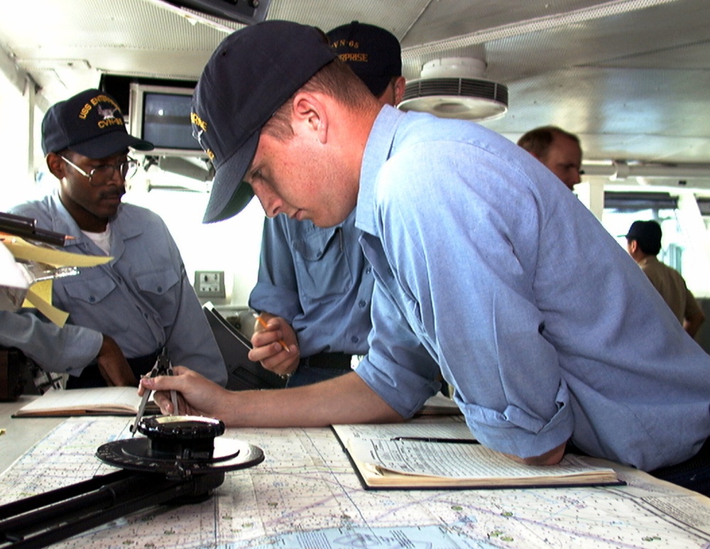 Seaman Jonathan Hawthorne plots the course of the USS Enterprise.