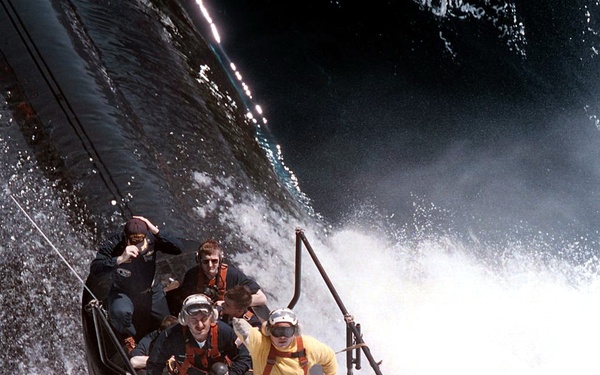USS Scranton (SSN 756) crew men stand by on the sail of the submarine.