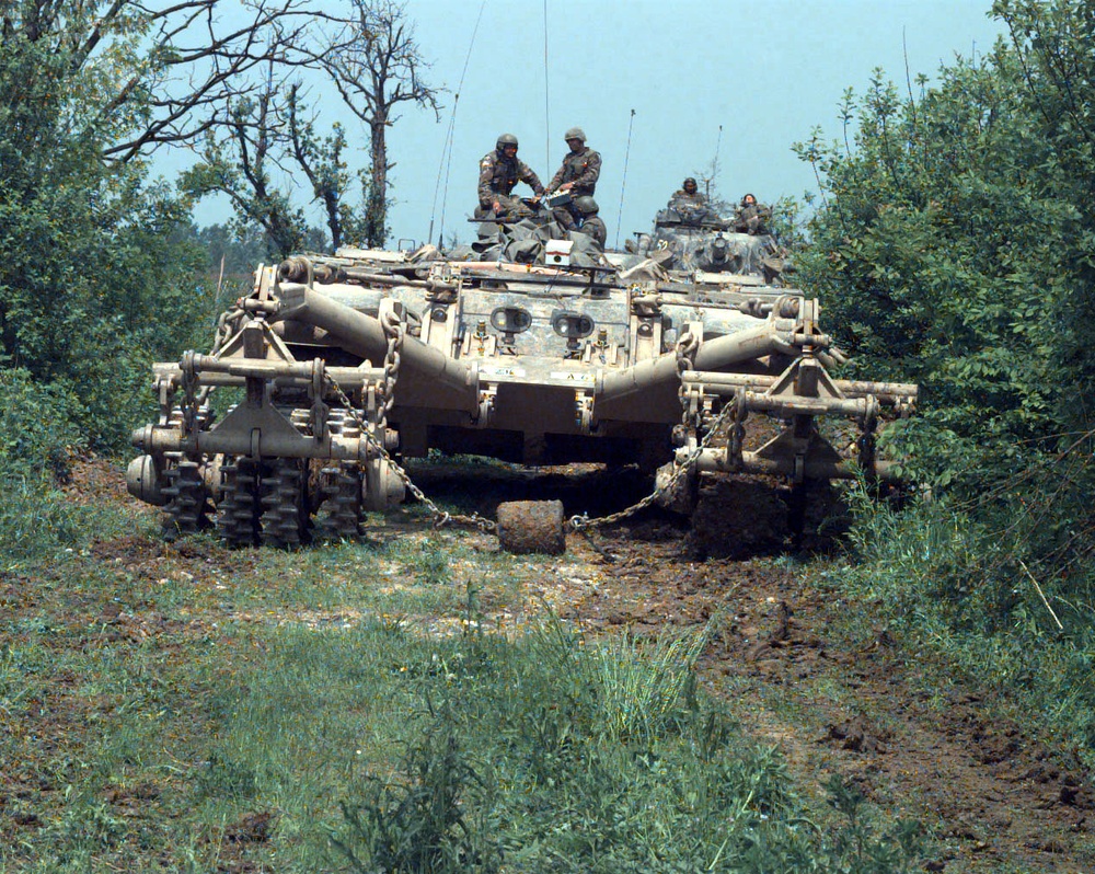 A Panther mine clearing vehicle leads a column of armored vehicles.