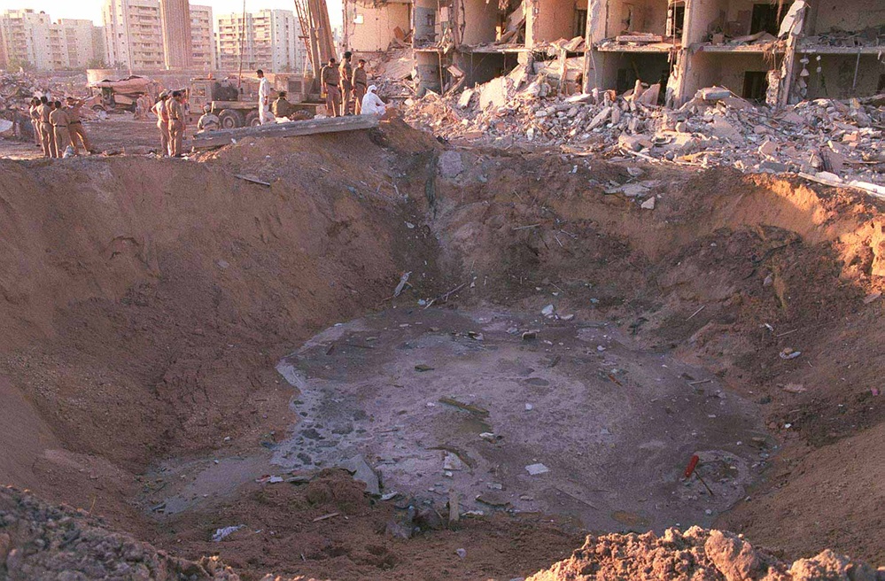 U.S. and Saudi military personnel peer into the crater caused by the explosion outside Khobar Towers on King Abdul Aziz Air Base near Dhahran, Saudi Arabia.