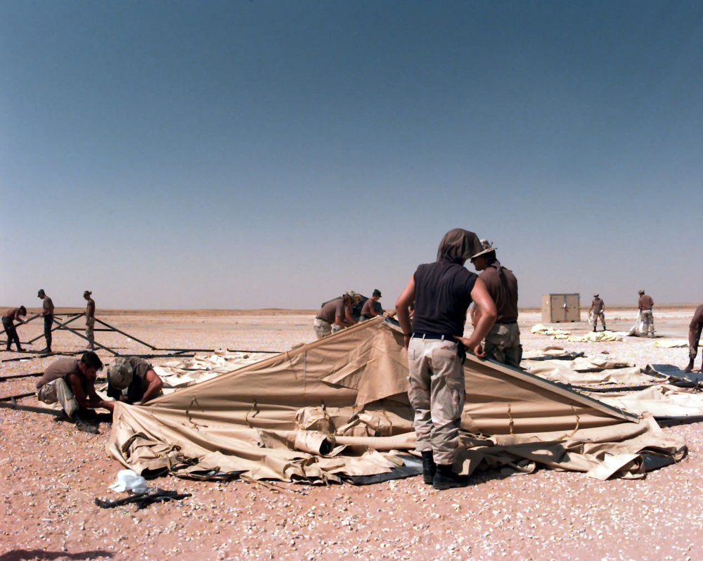 Air Force engineers get ready to raise a tent at Al Kharj, Saudi Arabia.