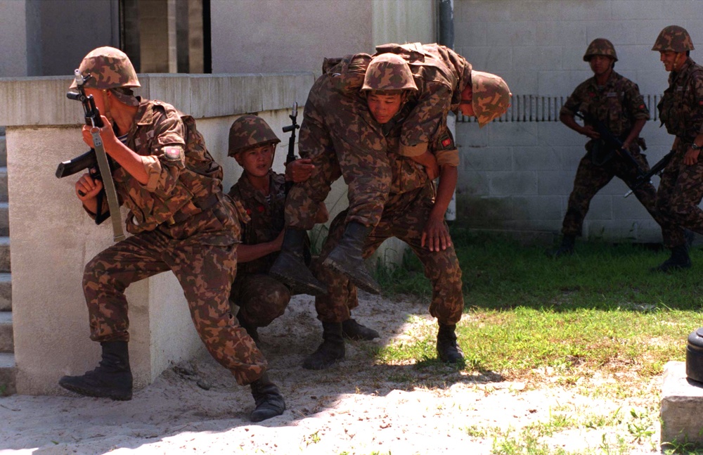 Kyrgystan soldiers carry a simulated wounded soldier to safety.