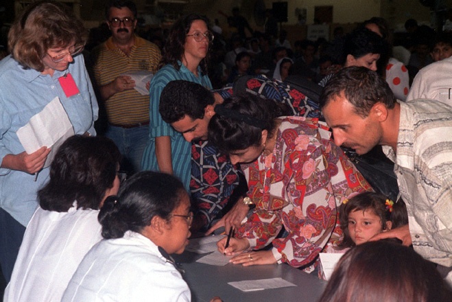 Kurdish evacuees begin filling out paperwork for asylum in the United States.