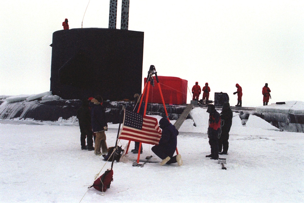 Scientists and crew members conduct experiments on the Arctic ice flow.