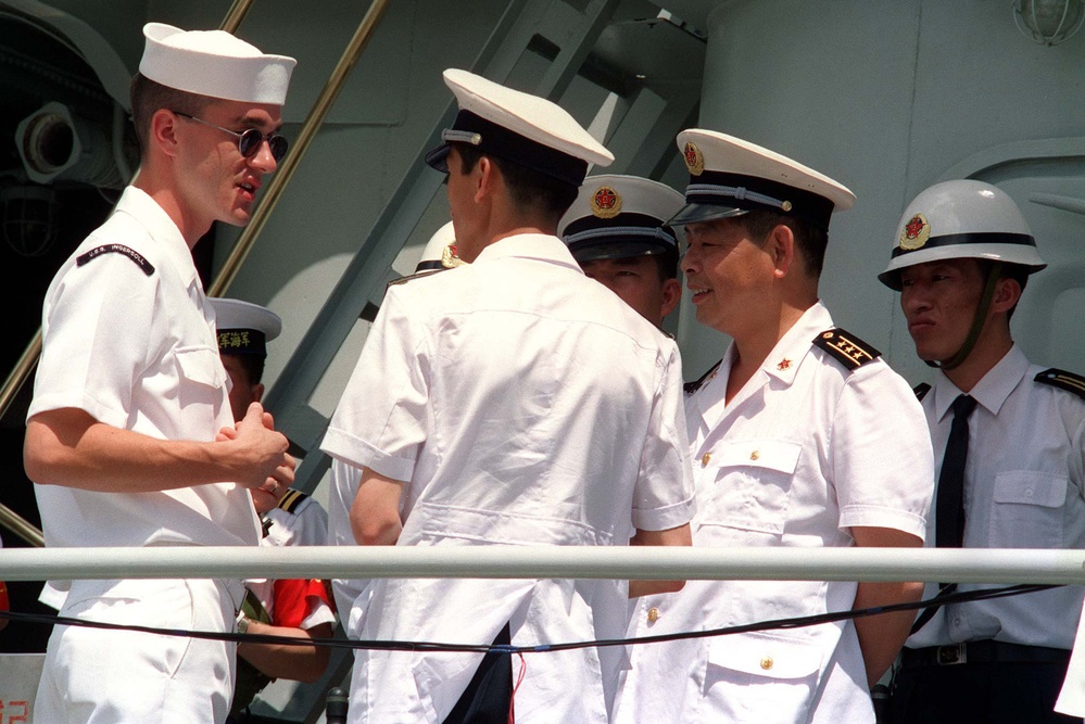 U.S. Navy sailor talks to People's Republic of China Navy sailors.