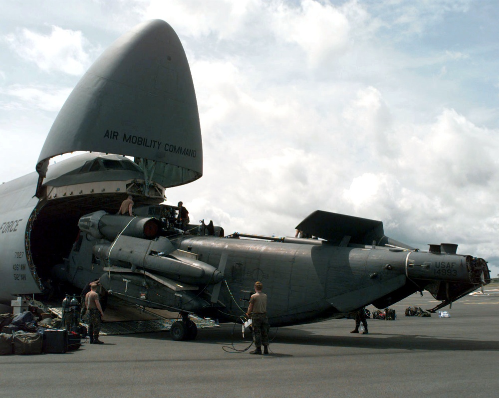 U.S. Air Force MH-53J Pave Low is unloaded from a C-5 at the Libreville airport.