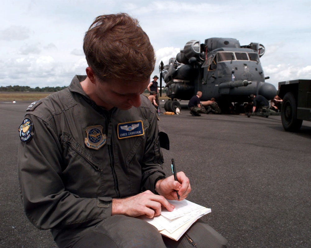 C-5 co-pilot Capt. Zabriskie fills out flight plans on the ramp at the Libreville International Airport.