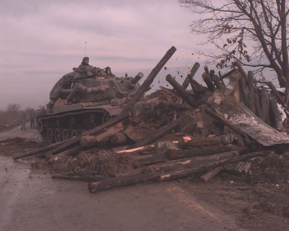 U.S. Army combat engineer vehicle demolishes a Bosnian Serb bunker on Route Arizona.
