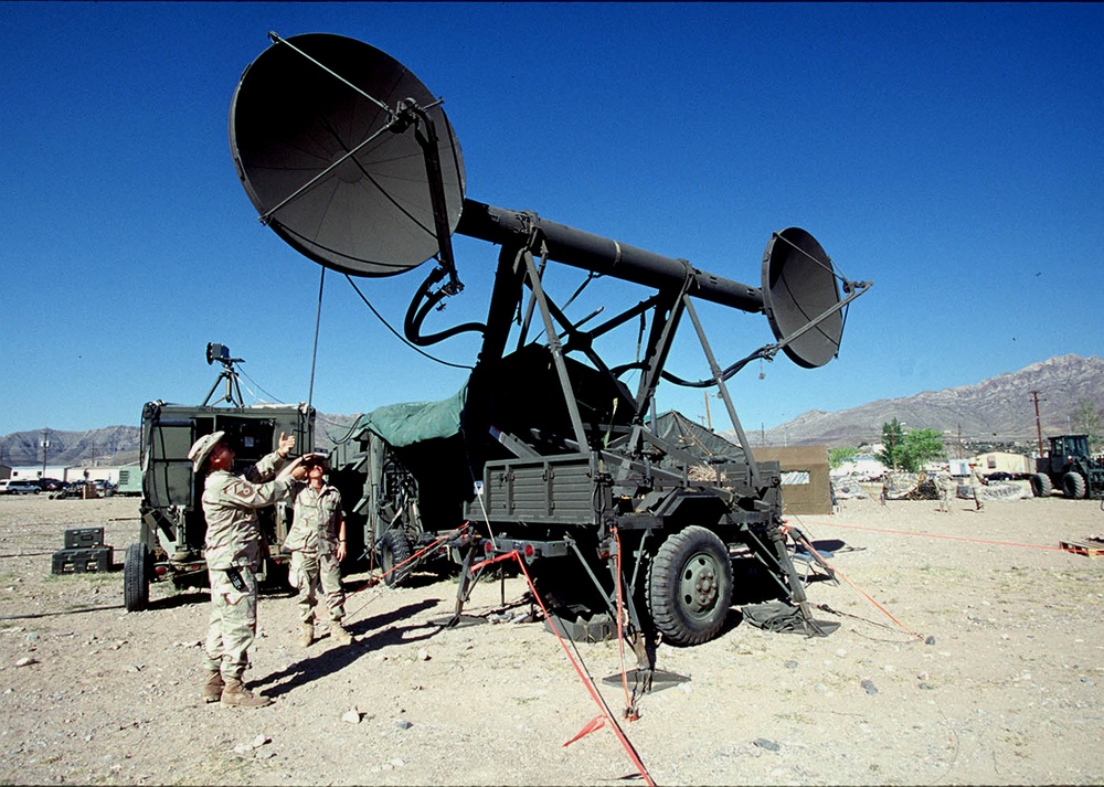 Two members of the 225th CCS set up a TRAC-170 Wideband System.