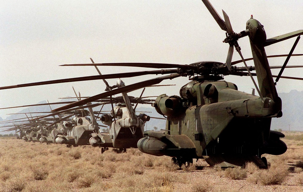 CH-53 Sea Stallions are parked in a line at the landing zone near Yuma, Ariz.