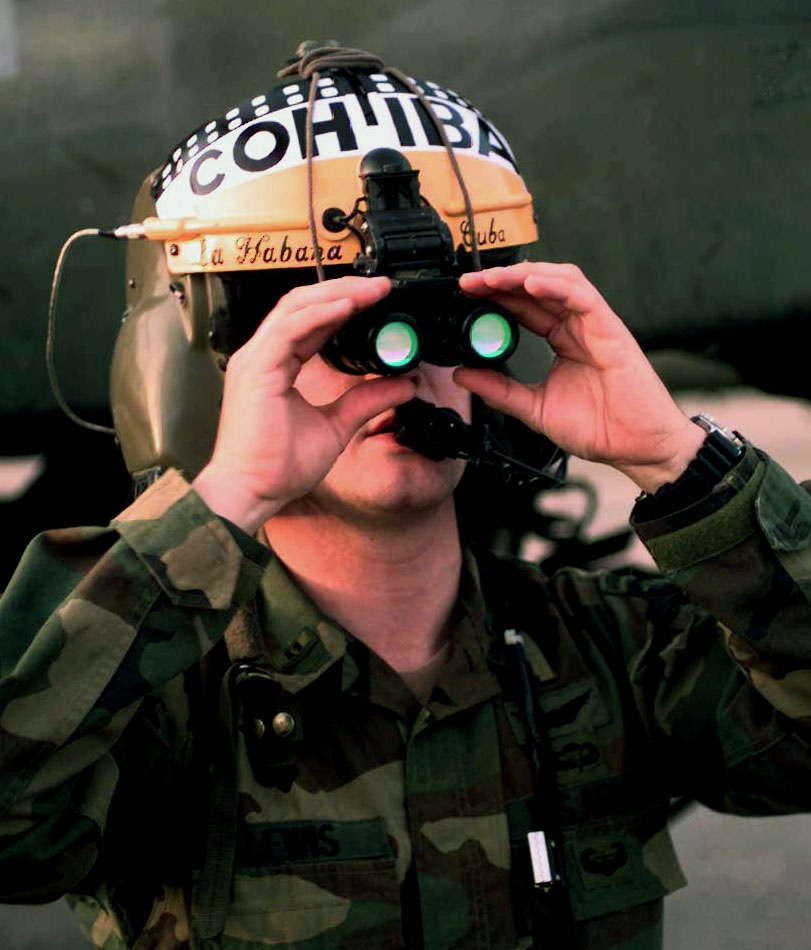 Chief Warrant Officer Myke Lewis positions his night vision goggles.