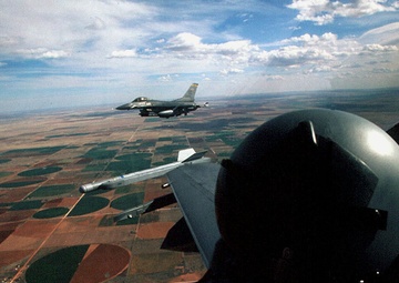 F-16 Fighting Falcons fly in a two ship formation before beginning a bombing mission.