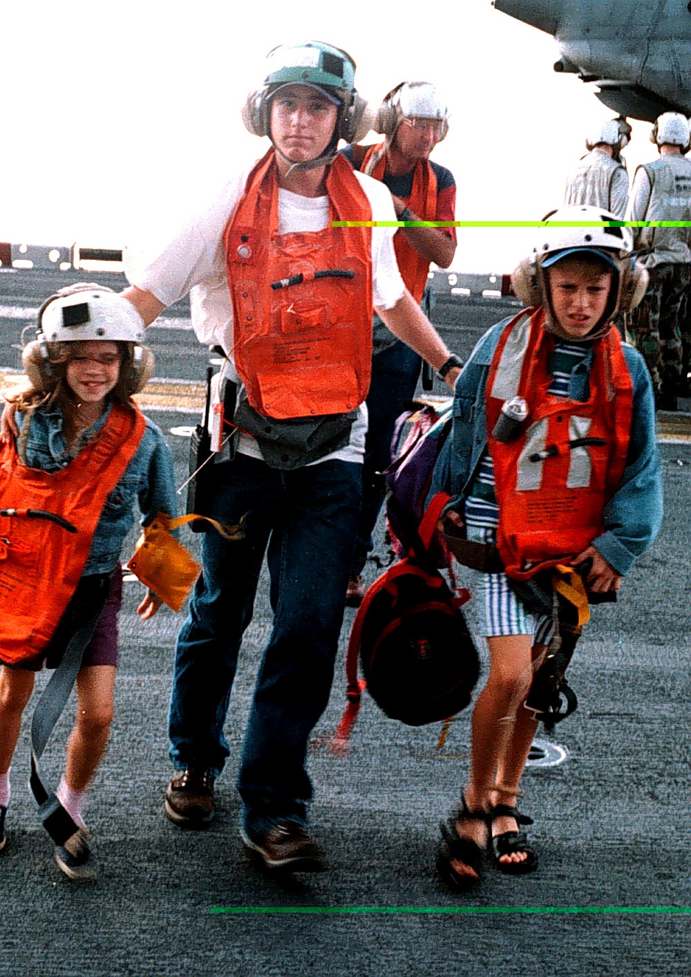 Evacuees from Freetown, Sierra Leone, rush across the flight deck of the USS Kearsarge.