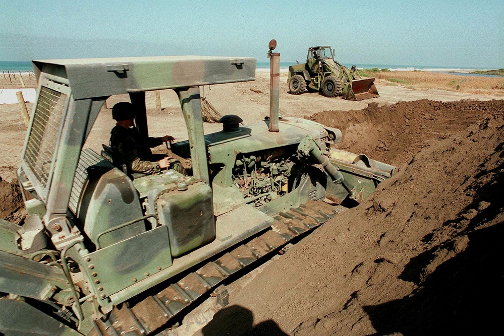 Soldiers dig a trench as one of the obstacles on Red Beach at Camp Pendleton.