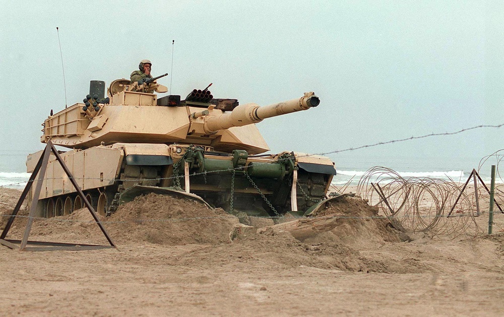 M-1A1 Abrams tank uses a mine plow to breach obstacles on Red Beach.