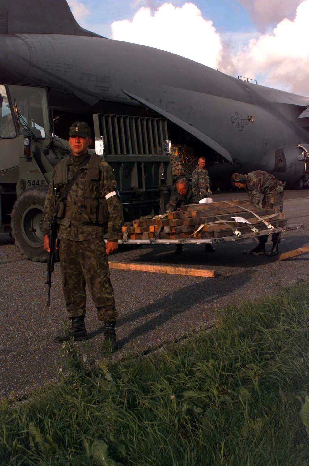 An Estonian soldier provides security for a U.S. Air Force C-5A Galaxy.