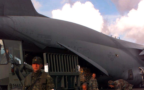 An Estonian soldier provides security for a U.S. Air Force C-5A Galaxy.