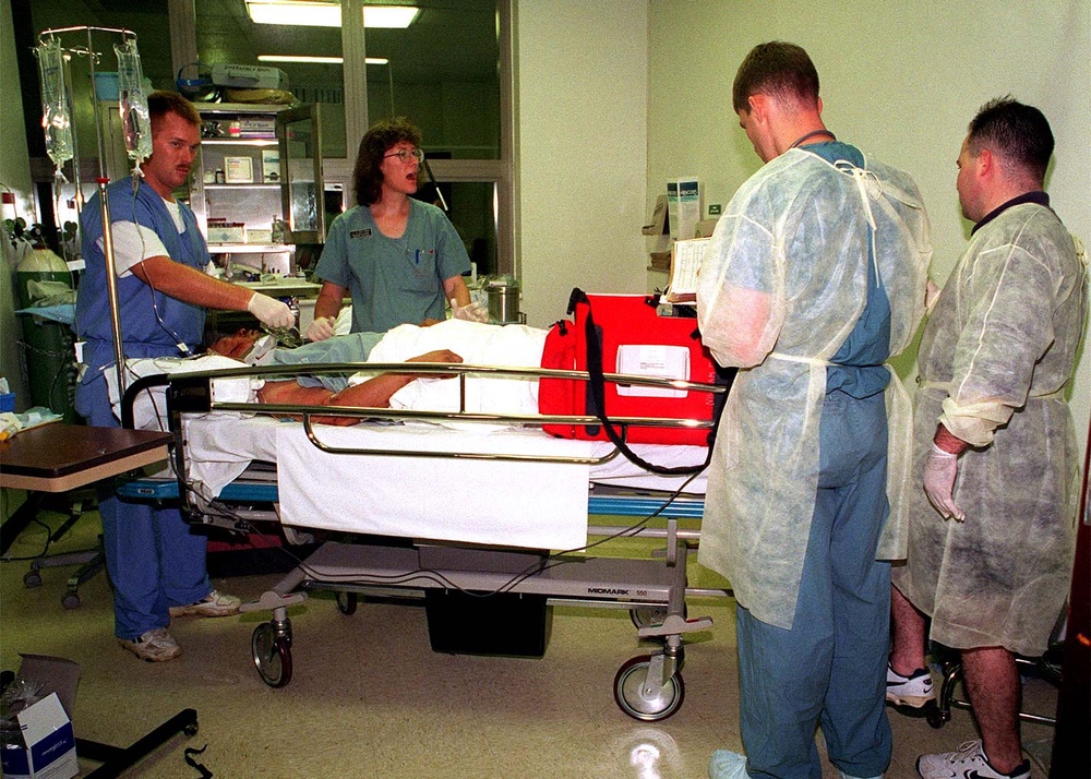 Navy medical personnel treat a survivor at U.S. Naval Hospital, Guam.