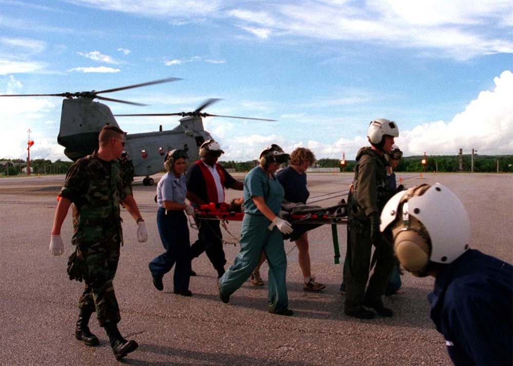 A survivor  of the Korean Airline crash is moved from an evacuation helicopter.