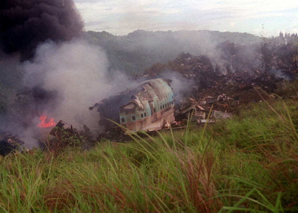 Wreckage of the Korean Airlines flight 801 burns at the Sasa Valley crash site.