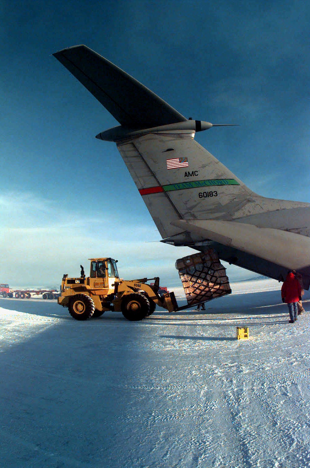 A C-141B Starlifter unloads cargo on a runway of ice at McMurdo Base, Antarctica.