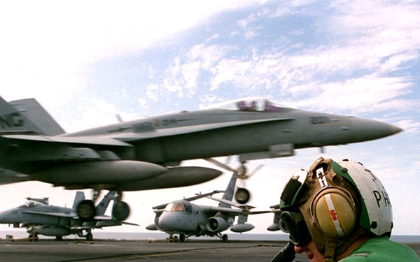 U.S. Navy Photographer's Mate uses a video camera to document Nimitz flight ops.