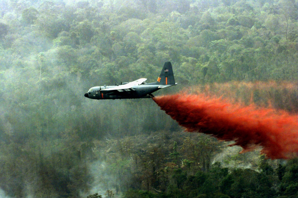 Air National Guard C-130 Hercules drops fire retardant on a Indonesian jungle fire.