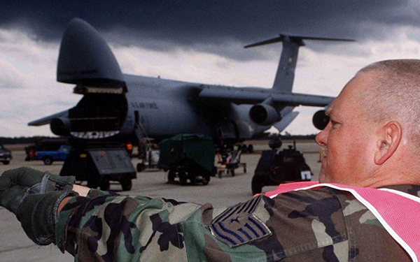 Tech. Sgt. Hodger tightens down a cargo strap on equipment for the Persian Gulf.