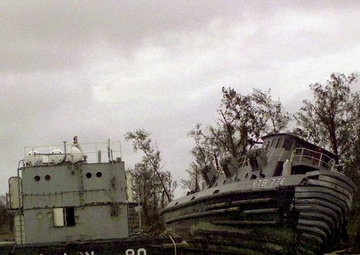 U.S. Navy barge and tug boat beached at Guam by super typhoon Paka.