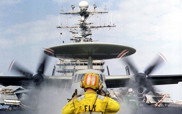Petty Officer Spurrell readies an E-2C Hawkeye for launch from the USS Nimitz.