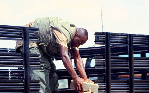 Marines unload deactivated anti-tank and anti-personnel land mines for destruction.