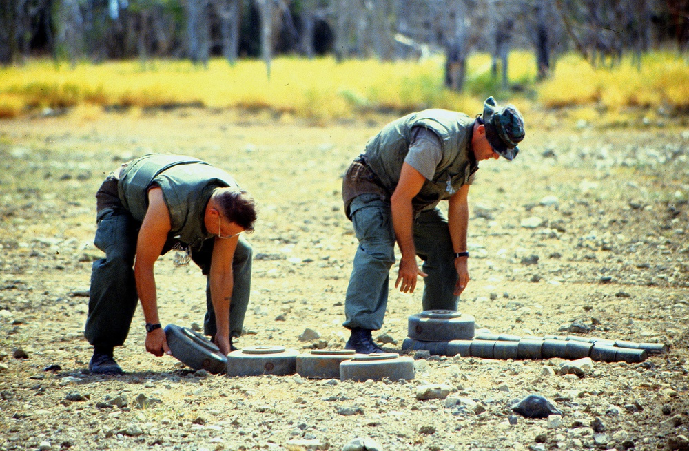 Anti-tank and anti-personnel land mines are stacked for destruction.