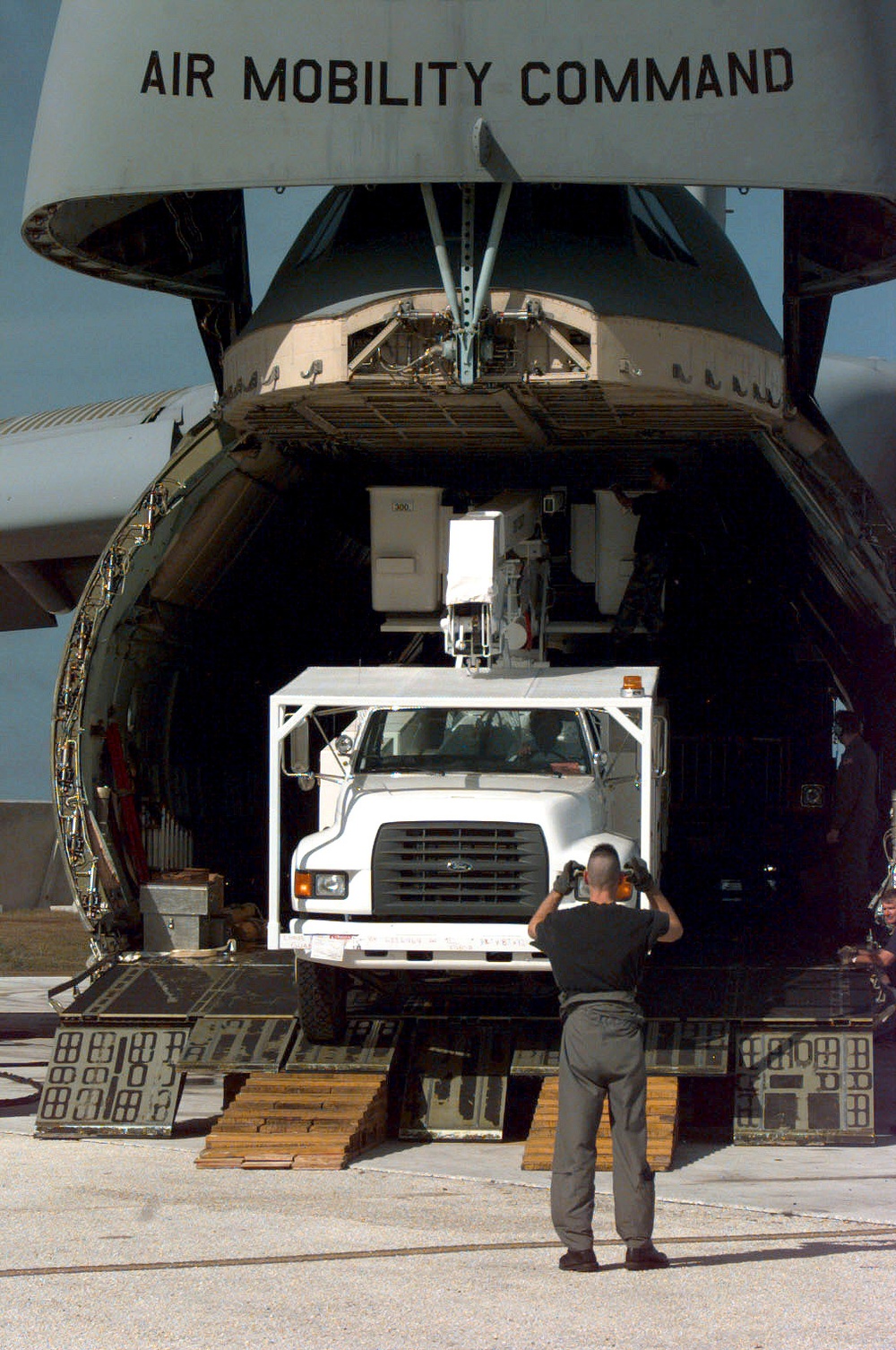 Air Force C-5 Galaxy delivers utility trucks to aid Guam after Super Typhoon Paka.
