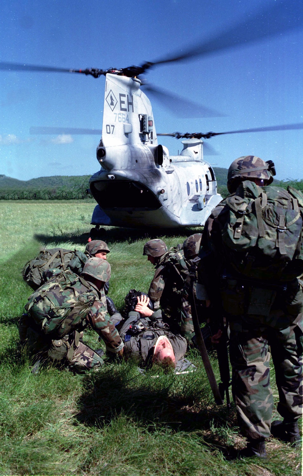 Marines tend to a simulated injured pilot during a Tactical Recovery of Aircraft and Personnel.