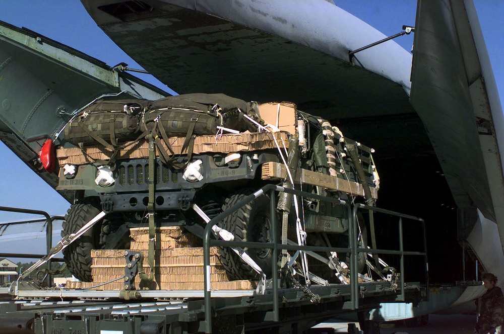 A Humvee prepared for an airdrop is blanketed with parachutes.