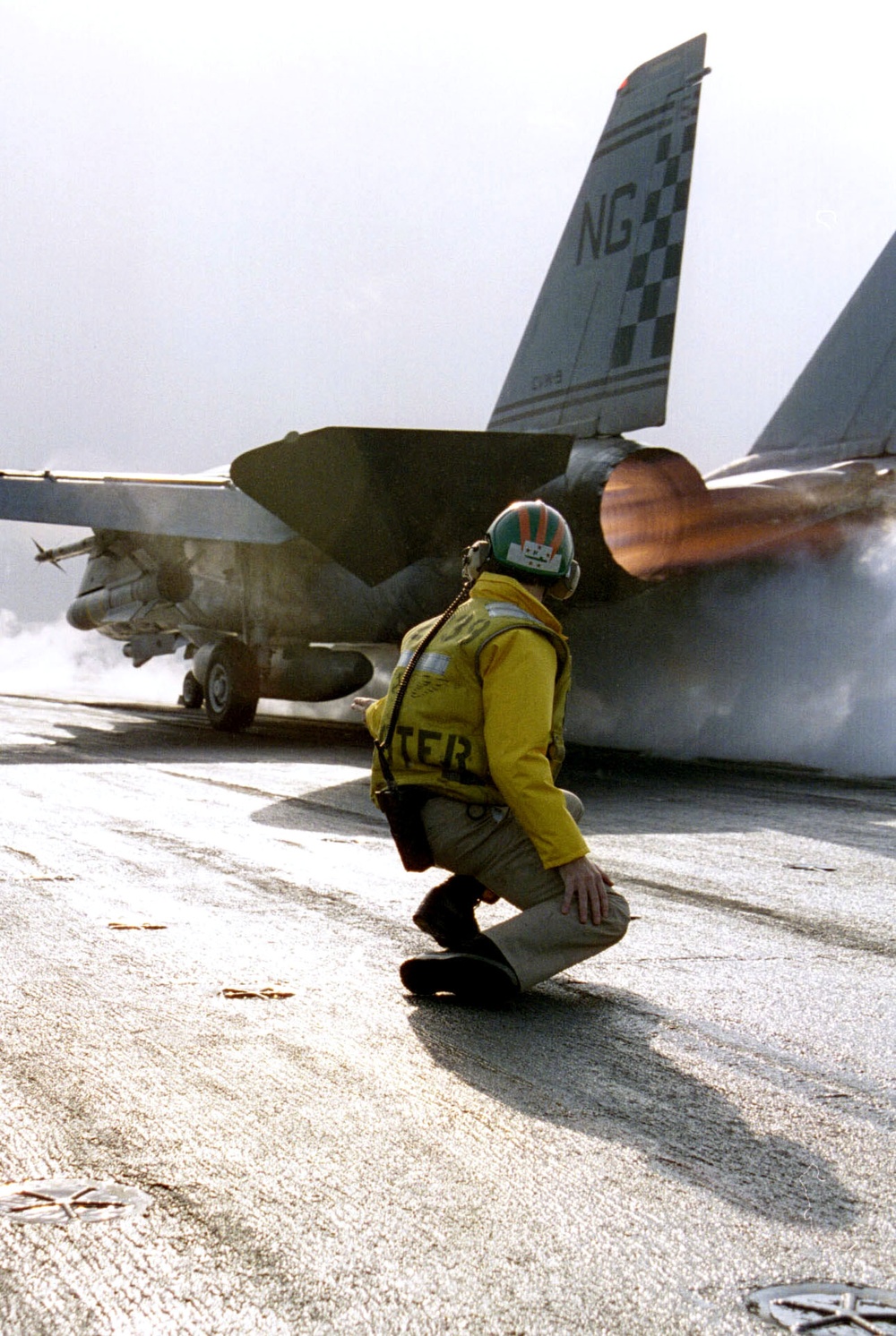 Lt. Rick Krystof watches an F-14 Tomcat hurtle down the catapult of the USS Nimitz.