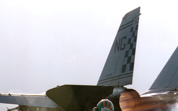 Lt. Rick Krystof watches an F-14 Tomcat hurtle down the catapult of the USS Nimitz.