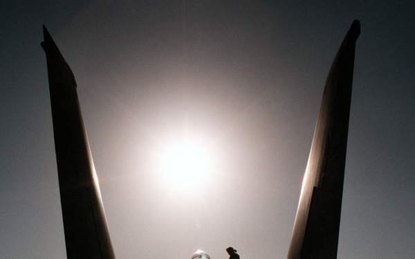 An aircraft mechanic works on an F-14B on the flight deck of the George Washington.