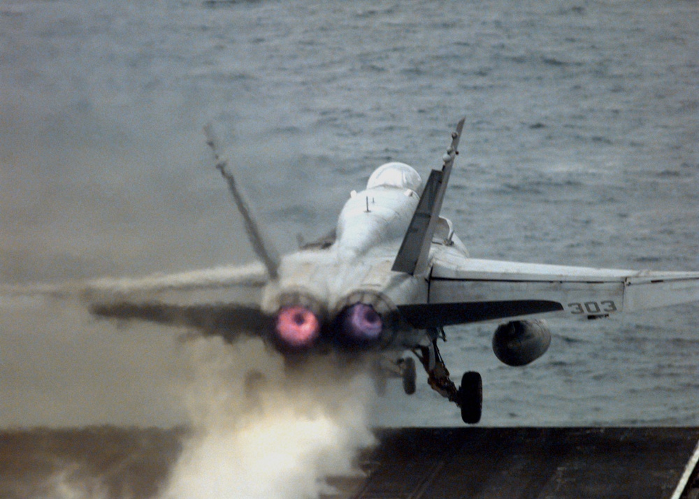 The afterburners of an Hornet glow as the aircraft is catapulted from the USS Independence.